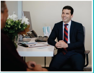 Dr Marius consulting with a patient