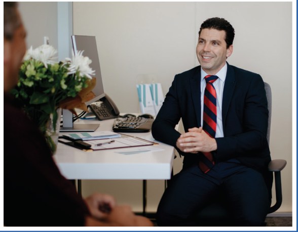 Dr Marius consulting with a patient