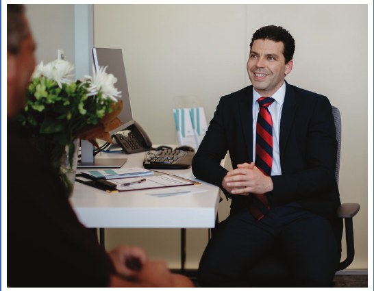 Dr Marius consulting with a patient
